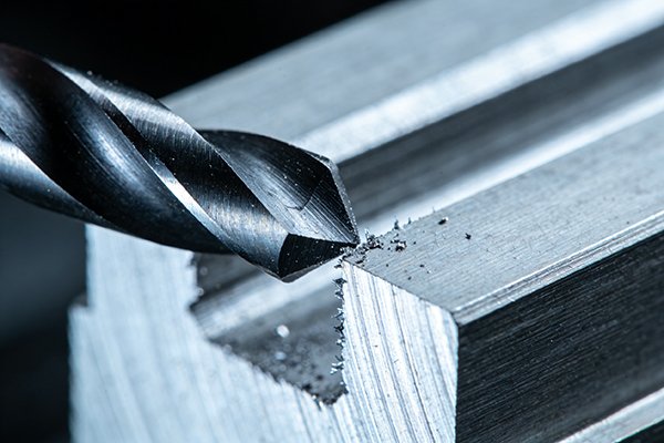 A chamfer mill deburring the edge of a machined part