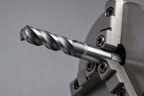 A close-up of an end mill shank being held in a tool holder