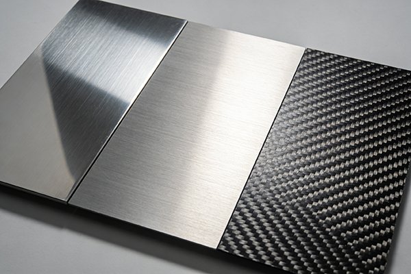 A collage of different materials like stainless steel, titanium, and carbon fiber.