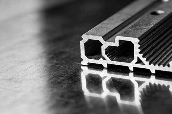 A perfectly flat metal surface next to a part with intricate contours.