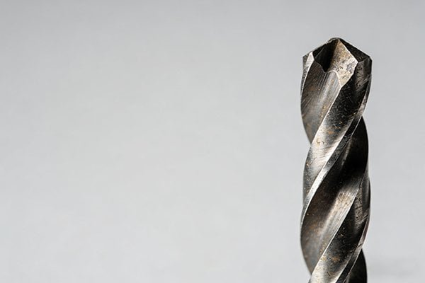 A standard HSS drill bit showing a worn cutting edge