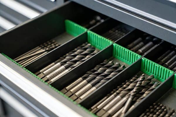 An organized drawer showing different series of NV-Tool carbide drills.