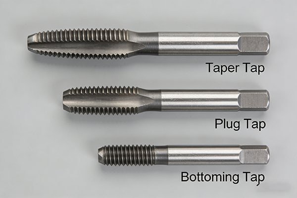 A set of three hand taps: taper, plug, and bottoming