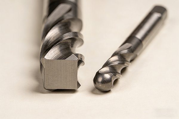 A square end mill next to a ball nose end mill
